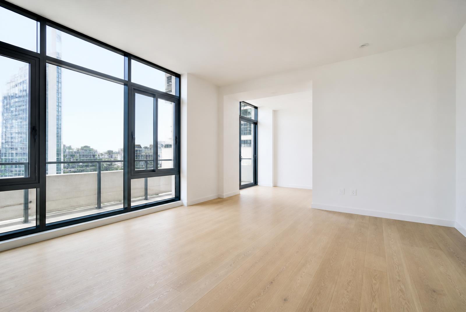 Empty modern apartment living room with bare oak floors and floor-to-ceiling windows, with a magnifying glass overlay emphasizing close inspection